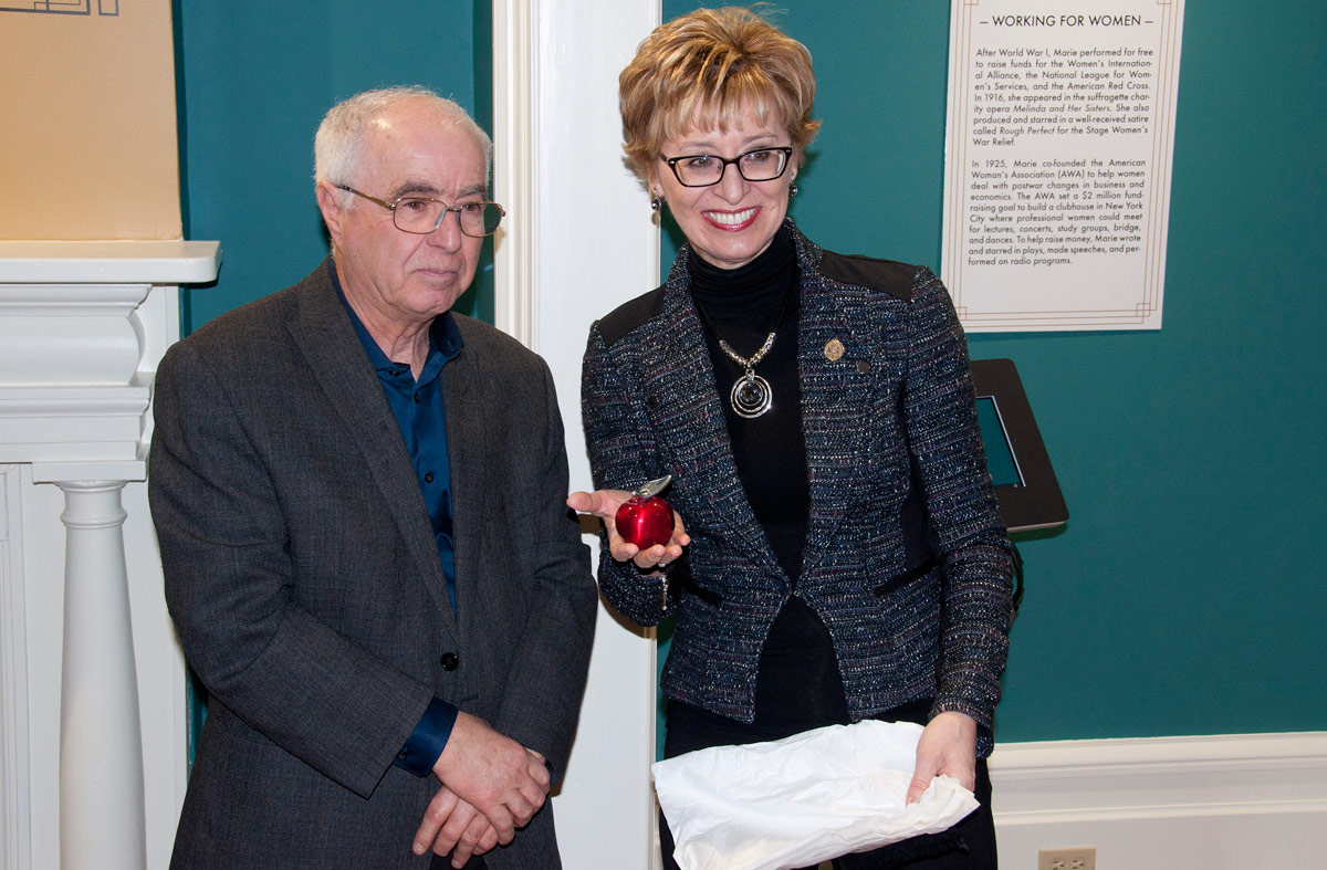 MPP Lou Rinaldi and Minister.  She is showing Hoselton Apple presented to her by Eileen Lum from the County.